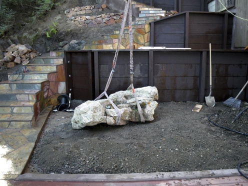 During construction, laying stone for fountain