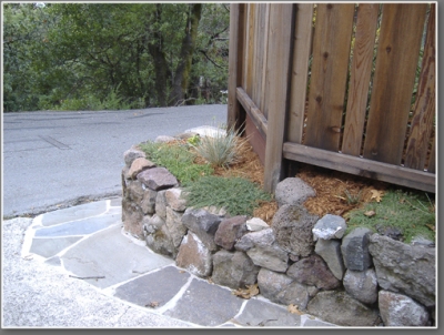 Edge of driveway after: using stone for steps and retaining wall.